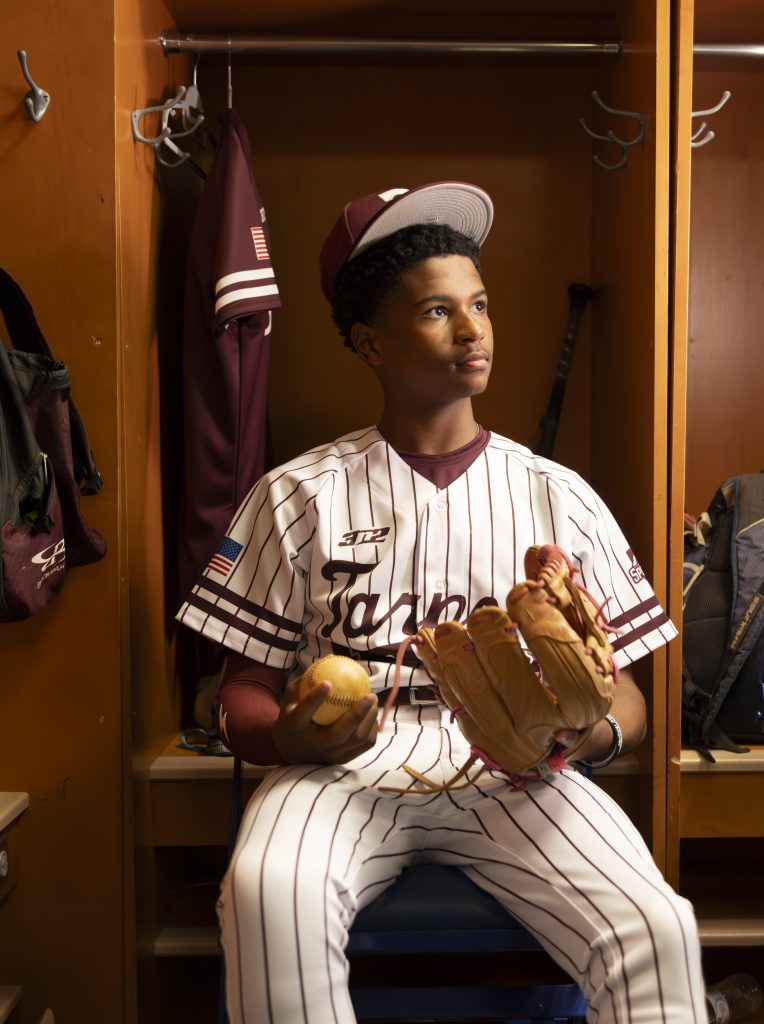 TSHS Waiting in Locker Room Tarpon Springs High School baseball player sitting in the locker room before a game, senior sports portrait in Tarpon Springs, Florida.